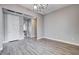 Large living room with light wood floors, a modern chandelier and neutral walls at 3012 Anna Bay Dr, Las Vegas, NV 89134