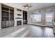 Spacious living room with a fireplace, built-in cabinets, and large windows at 3012 Anna Bay Dr, Las Vegas, NV 89134