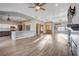 Bright and open living room featuring hardwood floors, a fireplace, and an open concept kitchen at 3012 Anna Bay Dr, Las Vegas, NV 89134