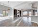 Large living room with fireplace, custom built-ins, recessed ceiling, and hardwood style floors at 3012 Anna Bay Dr, Las Vegas, NV 89134