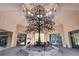 A sunlit lobby showcases an artful tree sculpture, with glass doors and a high ceiling with clerestory windows at 3012 Anna Bay Dr, Las Vegas, NV 89134