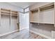 Walk-in closet with custom shelves, drawers, and hanging rods to organize wardrobe and doorway at 3012 Anna Bay Dr, Las Vegas, NV 89134