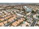Gorgeous aerial view of community featuring a lake, well-maintained landscaping, and terra cotta roofs at 3109 Siena Cir, Las Vegas, NV 89128