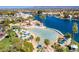 An aerial view of a resort-style pool and lakeside community with palm trees and blue umbrellas at 3109 Siena Cir, Las Vegas, NV 89128