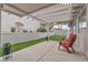 Relaxing outdoor area with patio, artificial grass, and tranquil landscaping at 3109 Siena Cir, Las Vegas, NV 89128