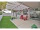 Inviting backyard with artificial grass, patio space, and mature trees for outdoor enjoyment at 3109 Siena Cir, Las Vegas, NV 89128