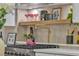 Modern kitchen features stainless steel appliances, open shelving and gold pot filler faucet at 3109 Siena Cir, Las Vegas, NV 89128