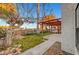 Lush backyard with a covered patio and mature trees providing shade and privacy at 3152 Centavo Dr, Las Vegas, NV 89117