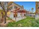 Large backyard with a covered patio and mature landscaping offers a tranquil retreat at 3152 Centavo Dr, Las Vegas, NV 89117