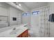 Bright bathroom with a tub-shower combo and a vanity with a large mirror at 3152 Centavo Dr, Las Vegas, NV 89117