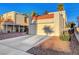 Exterior shot of charming stucco home featuring a driveway and attached garage with a red tile roof at 3152 Centavo Dr, Las Vegas, NV 89117