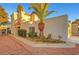 Exterior shot of charming home featuring desert landscaping, decorative rock, and a mature palm tree at 3152 Centavo Dr, Las Vegas, NV 89117