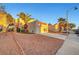 Exterior shot of charming home featuring an attached garage, desert landscaping, and a mature palm tree at 3152 Centavo Dr, Las Vegas, NV 89117