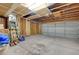 Spacious garage with exposed beams and a roll-up door, ready for your projects at 3152 Centavo Dr, Las Vegas, NV 89117