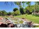 Beautiful view of the pond with rock features and surrounding grassy common area at 3152 Centavo Dr, Las Vegas, NV 89117