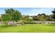 Street view showcasing lush green lawns, mature trees, and picturesque homes along a tranquil canal at 3152 Centavo Dr, Las Vegas, NV 89117