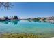 Stunning view of clear blue waters with waterfront homes and palm trees in the background, highlighting a serene lifestyle at 3152 Centavo Dr, Las Vegas, NV 89117