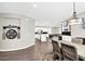 Open-concept dining room with hardwood floors, modern lighting, and adjacent to the kitchen and living area at 3155 Mossfield Ave, Henderson, NV 89052