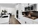 Modern kitchen design showcasing white cabinets, stainless steel appliances, and stylish black backsplash at 3155 Mossfield Ave, Henderson, NV 89052