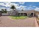 Exterior of the back of the home featuring a covered patio and green space at 33 Chateau Whistler Ct, Las Vegas, NV 89148