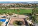 Aerial view of a backyard with a pool and golf course view in a lush community at 33 Chateau Whistler Ct, Las Vegas, NV 89148