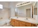 Bright bathroom with double sink vanity, large mirror, tiled floors, and a shower over tub at 33 Chateau Whistler Ct, Las Vegas, NV 89148