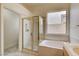 Bathroom featuring tub-shower combination and a window for natural light at 33 Chateau Whistler Ct, Las Vegas, NV 89148