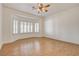 Bright bedroom featuring hardwood floors, shuttered bay windows, and a ceiling fan at 33 Chateau Whistler Ct, Las Vegas, NV 89148