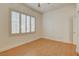 Empty bedroom featuring wood floors, a shuttered window, neutral paint and a closet at 33 Chateau Whistler Ct, Las Vegas, NV 89148