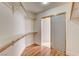 Walk-in closet with wooden floors, shelves, and a mirrored sliding door at 33 Chateau Whistler Ct, Las Vegas, NV 89148