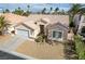 Inviting single-story home featuring desert landscaping, two-car garage, and desert landscaping at 33 Chateau Whistler Ct, Las Vegas, NV 89148
