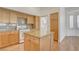 Traditional kitchen with wooden cabinets, granite countertops, and a central island at 33 Chateau Whistler Ct, Las Vegas, NV 89148