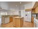 Well-equipped kitchen with stainless steel appliances, wooden cabinets, and a central island at 33 Chateau Whistler Ct, Las Vegas, NV 89148