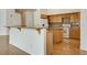 Spacious kitchen featuring a breakfast bar, wood cabinets, and modern appliances at 33 Chateau Whistler Ct, Las Vegas, NV 89148