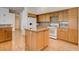 Bright kitchen featuring wood cabinets, granite countertops, and a central island at 33 Chateau Whistler Ct, Las Vegas, NV 89148