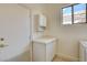 Laundry room with white cabinetry and tile floors at 33 Chateau Whistler Ct, Las Vegas, NV 89148