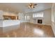 Bright living room with hardwood floors, fireplace, bay window, and views of the kitchen at 33 Chateau Whistler Ct, Las Vegas, NV 89148