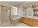 Main bathroom featuring double vanity, tub, and stand-alone shower at 33 Chateau Whistler Ct, Las Vegas, NV 89148