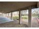Wide angle view of a covered patio overlooking a yard with greenery and palm trees at 33 Chateau Whistler Ct, Las Vegas, NV 89148