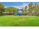 Brightly colored playground equipment sits on a well-maintained green lawn for community fun at 33 Chateau Whistler Ct, Las Vegas, NV 89148