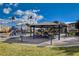 Community playground with picnic tables, BBQ grills and slide surrounded by grass at 33 Chateau Whistler Ct, Las Vegas, NV 89148