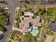 An aerial view shows the pool, patio, multiple roof lines and surrounding landscaping at 3680 Belvedere Park Ln, Las Vegas, NV 89141