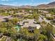 Aerial shot of a luxurious home, swimming pool, and meticulously landscaped backyard at 3680 Belvedere Park Ln, Las Vegas, NV 89141