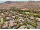 Expansive aerial view of a luxury community featuring lush landscaping and golf course views at 3680 Belvedere Park Ln, Las Vegas, NV 89141