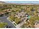 Aerial view showcasing a luxurious home with a pool, palm trees, and well-maintained landscaping at 3680 Belvedere Park Ln, Las Vegas, NV 89141