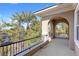 A covered balcony featuring decorative arches and wrought iron railing offering scenic views at 3680 Belvedere Park Ln, Las Vegas, NV 89141