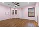 A pink bedroom with hardwood flooring, shutters, and a ceiling fan at 3680 Belvedere Park Ln, Las Vegas, NV 89141