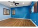 A brightly painted bedroom with hardwood flooring and window shutters at 3680 Belvedere Park Ln, Las Vegas, NV 89141