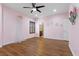 A pink bedroom with hardwood flooring, shutters, and a ceiling fan at 3680 Belvedere Park Ln, Las Vegas, NV 89141