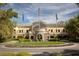 Beautiful clubhouse with manicured landscaping, circular driveway, and flags on a sunny day at 3680 Belvedere Park Ln, Las Vegas, NV 89141
